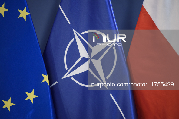 European Union (EU), NATO, and Poland's national flags are pictured during a press conference in Warsaw, Poland, on November 8, 2024. The Mi...