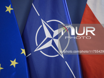 European Union (EU), NATO, and Poland's national flags are pictured during a press conference in Warsaw, Poland, on November 8, 2024. The Mi...