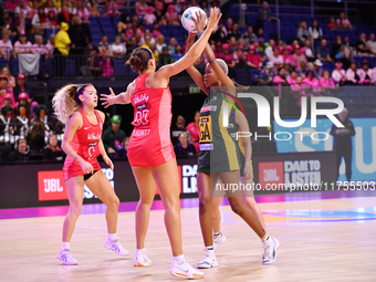 Kamogelo Maseko of South Africa and Zara Everitt of England compete for the ball during the Fast5 Netball World Series match between England...