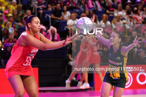 Paige Reed of England (L) passes the ball during the Fast5 Netball World Series match between England and South Africa at the Wolfbrook Aren...