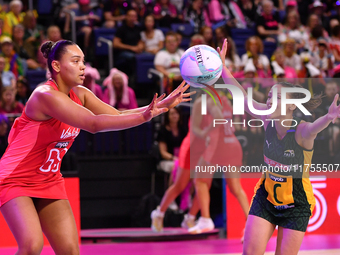 Paige Reed of England (L) passes the ball during the Fast5 Netball World Series match between England and South Africa at the Wolfbrook Aren...