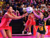 Paige Reed of England (L) passes the ball during the Fast5 Netball World Series match between England and South Africa at the Wolfbrook Aren...