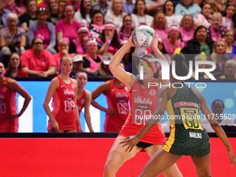 Harriet Jones of England (L) passes the ball during the Fast5 Netball World Series match between England and South Africa at the Wolfbrook A...