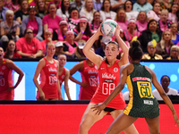 Harriet Jones of England (L) passes the ball during the Fast5 Netball World Series match between England and South Africa at the Wolfbrook A...