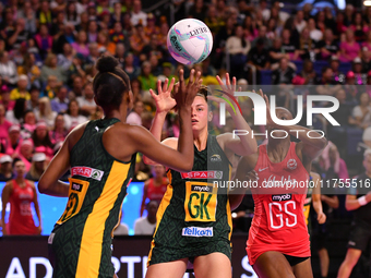 Boitumelo Mahloko (L) and Ane Retief (C) of South Africa compete with Sophie Egbaran of England for the ball during the Fast5 Netball World...