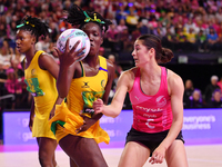 Kimone Shaw of Jamaica (center) and Georgie Edgecombe of New Zealand (right) compete in the Fast5 Netball World Series match between New Zea...