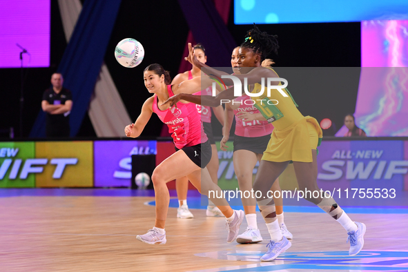 Zaudi Green of Jamaica (R) passes the ball during the Fast5 Netball World Series match between New Zealand and Jamaica in Christchurch, New...