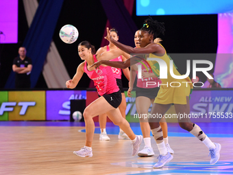 Zaudi Green of Jamaica (R) passes the ball during the Fast5 Netball World Series match between New Zealand and Jamaica in Christchurch, New...