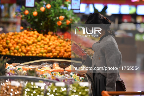 A consumer buys goods at a supermarket in Fuyang, China, on November 9, 2024. The consumer price index (CPI) rises 0.3 percent year on year...