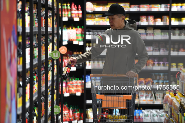 A consumer buys goods at a supermarket in Fuyang, China, on November 9, 2024. The consumer price index (CPI) rises 0.3 percent year on year...