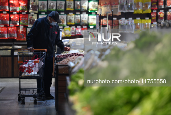 A consumer buys goods at a supermarket in Fuyang, China, on November 9, 2024. The consumer price index (CPI) rises 0.3 percent year on year...