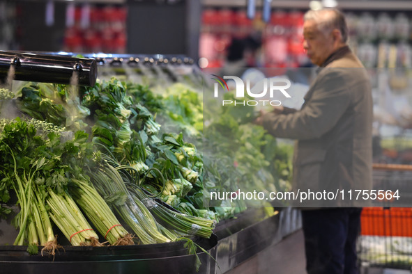 A consumer buys goods at a supermarket in Fuyang, China, on November 9, 2024. The consumer price index (CPI) rises 0.3 percent year on year...