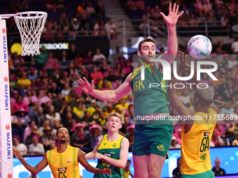 Alastair Punshon of Australia (C) and Eugene Sinxezi of South Africa (R) compete in the Fast5 Netball World Series match between Australia a...