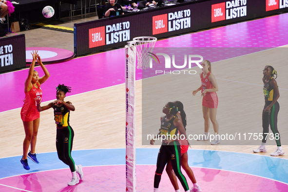 Paige Reed of England (L) shoots during the Fast5 Netball World Series match between England and Jamaica at the Wolfbrook Arena in Christchu...