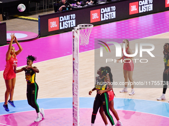 Paige Reed of England (L) shoots during the Fast5 Netball World Series match between England and Jamaica at the Wolfbrook Arena in Christchu...