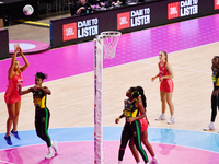 Paige Reed of England (L) shoots during the Fast5 Netball World Series match between England and Jamaica at the Wolfbrook Arena in Christchu...