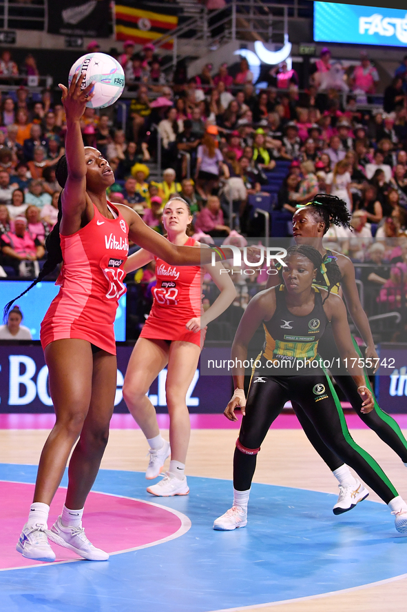 Sophie Egbaran of England (L) catches the ball during the Fast5 Netball World Series match between England and Jamaica at the Wolfbrook Aren...