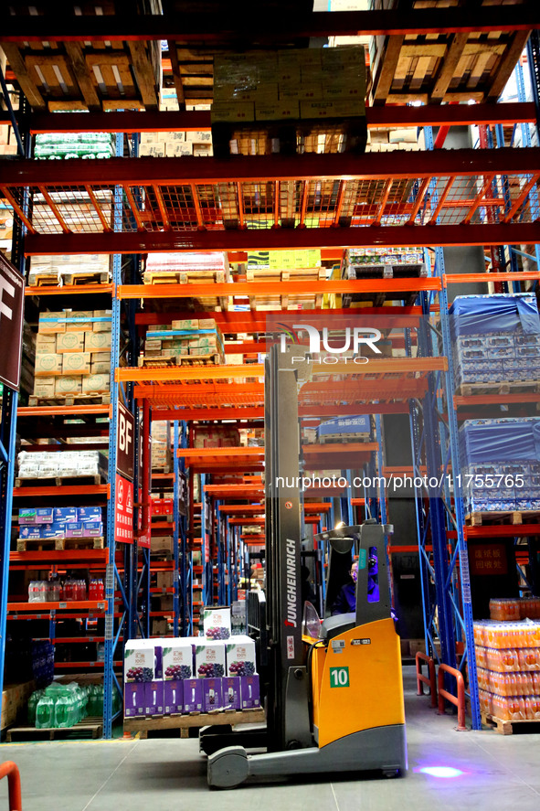 A staff member transfers goods at an e-commerce logistics warehouse in Lianyun district, Lianyungang, China, on November 9, 2024. 