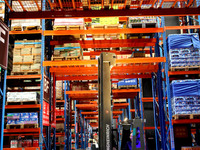 A staff member transfers goods at an e-commerce logistics warehouse in Lianyun district, Lianyungang, China, on November 9, 2024. (