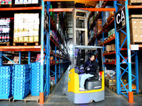 A staff member transfers goods at an e-commerce logistics warehouse in Lianyun district, Lianyungang, China, on November 9, 2024. (