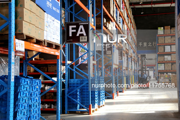 A staff member transfers goods at an e-commerce logistics warehouse in Lianyun district, Lianyungang, China, on November 9, 2024. 