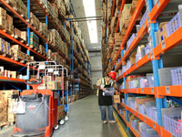 A staff member transfers goods at an e-commerce logistics warehouse in Lianyun district, Lianyungang, China, on November 9, 2024. (