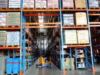 A staff member transfers goods at an e-commerce logistics warehouse in Lianyun district, Lianyungang, China, on November 9, 2024. (