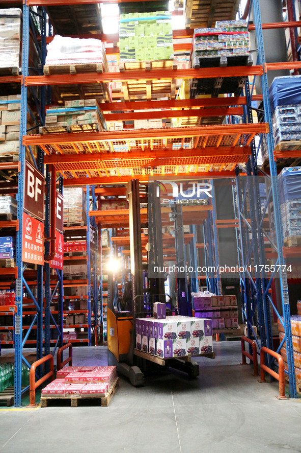 A staff member transfers goods at an e-commerce logistics warehouse in Lianyun district, Lianyungang, China, on November 9, 2024. 