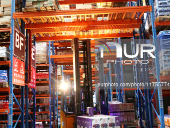 A staff member transfers goods at an e-commerce logistics warehouse in Lianyun district, Lianyungang, China, on November 9, 2024. (