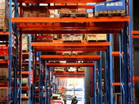 A staff member transfers goods at an e-commerce logistics warehouse in Lianyun district, Lianyungang, China, on November 9, 2024. (