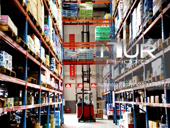 A staff member transfers goods at an e-commerce logistics warehouse in Lianyun district, Lianyungang, China, on November 9, 2024. (