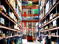 A staff member transfers goods at an e-commerce logistics warehouse in Lianyun district, Lianyungang, China, on November 9, 2024. (