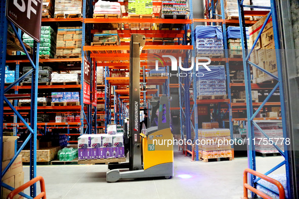 A staff member transfers goods at an e-commerce logistics warehouse in Lianyun district, Lianyungang, China, on November 9, 2024. 