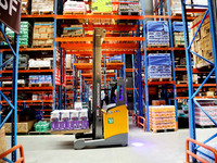 A staff member transfers goods at an e-commerce logistics warehouse in Lianyun district, Lianyungang, China, on November 9, 2024. (