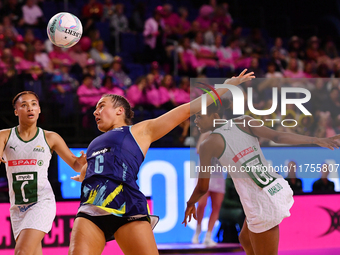 Amy Sligar of Australia, South Africa's Boitumelo Mahloko, and Amber Coraizin compete in the Fast5 Netball World Series match between Austra...