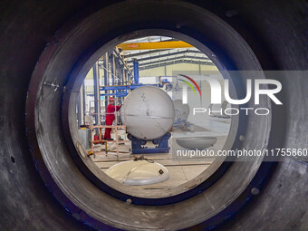 A worker works at a gas purification equipment manufacturing company in Qingzhou Economic Development Zone in Qingzhou, China, on November 9...