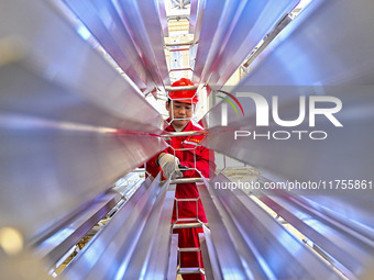 A worker works at a gas purification equipment manufacturing company in Qingzhou Economic Development Zone in Qingzhou, China, on November 9...