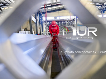 A worker works at a gas purification equipment manufacturing company in Qingzhou Economic Development Zone in Qingzhou, China, on November 9...