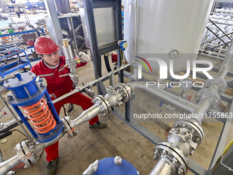 A worker works at a gas purification equipment manufacturing company in Qingzhou Economic Development Zone in Qingzhou, China, on November 9...