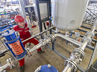 A worker works at a gas purification equipment manufacturing company in Qingzhou Economic Development Zone in Qingzhou, China, on November 9...