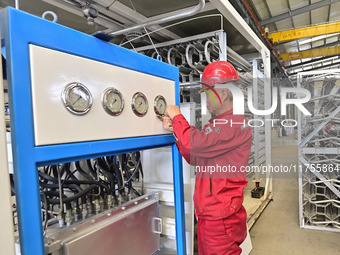 A worker works at a gas purification equipment manufacturing company in Qingzhou Economic Development Zone in Qingzhou, China, on November 9...