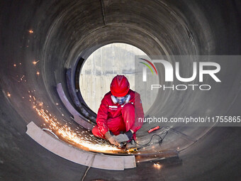 A worker works at a gas purification equipment manufacturing company in Qingzhou Economic Development Zone in Qingzhou, China, on November 9...