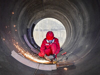 A worker works at a gas purification equipment manufacturing company in Qingzhou Economic Development Zone in Qingzhou, China, on November 9...