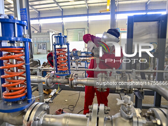 A worker works at a gas purification equipment manufacturing company in Qingzhou Economic Development Zone in Qingzhou, China, on November 9...