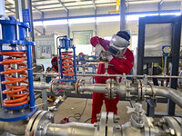 A worker works at a gas purification equipment manufacturing company in Qingzhou Economic Development Zone in Qingzhou, China, on November 9...