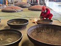 A worker works at a gas purification equipment manufacturing company in Qingzhou Economic Development Zone in Qingzhou, China, on November 9...