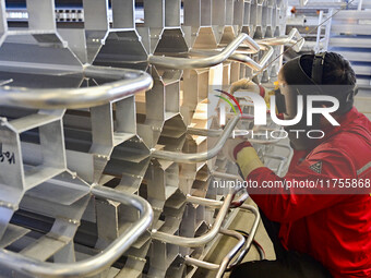 A worker works at a gas purification equipment manufacturing company in Qingzhou Economic Development Zone in Qingzhou, China, on November 9...