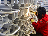 A worker works at a gas purification equipment manufacturing company in Qingzhou Economic Development Zone in Qingzhou, China, on November 9...