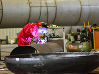 A worker works at a gas purification equipment manufacturing company in Qingzhou Economic Development Zone in Qingzhou, China, on November 9...