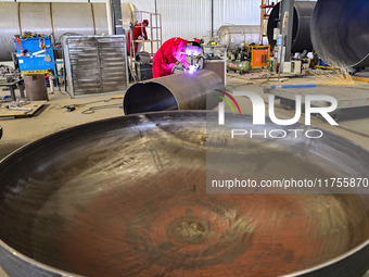 A worker works at a gas purification equipment manufacturing company in Qingzhou Economic Development Zone in Qingzhou, China, on November 9...